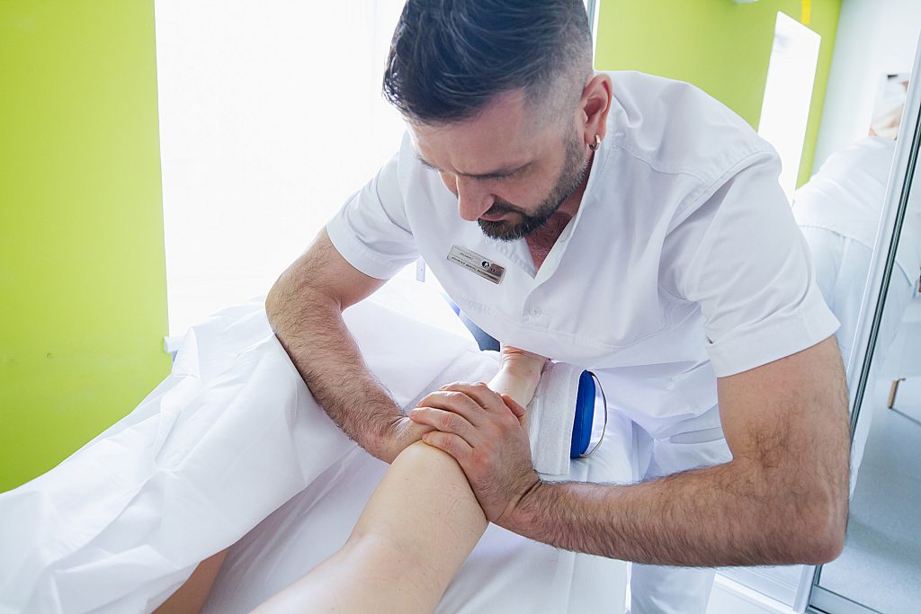 A restorative foot massage is performed by a massage therapist.